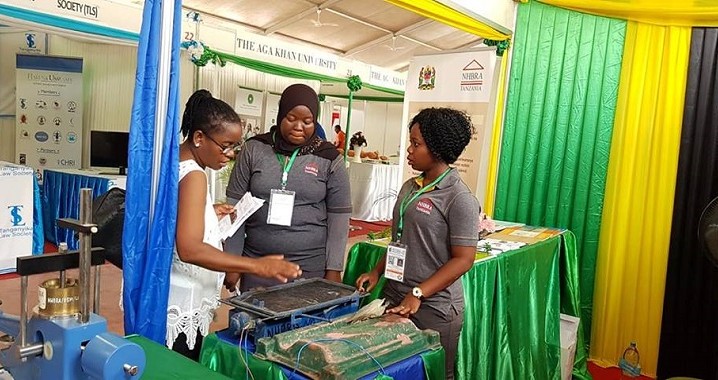 Wafanyakazi wa NHBRA wakitoa maelezo  juu ya mashine ya kutengenezea vigae kwa mwananchi aliyetembelea banda wakati wa maonesho ya Sabasaba